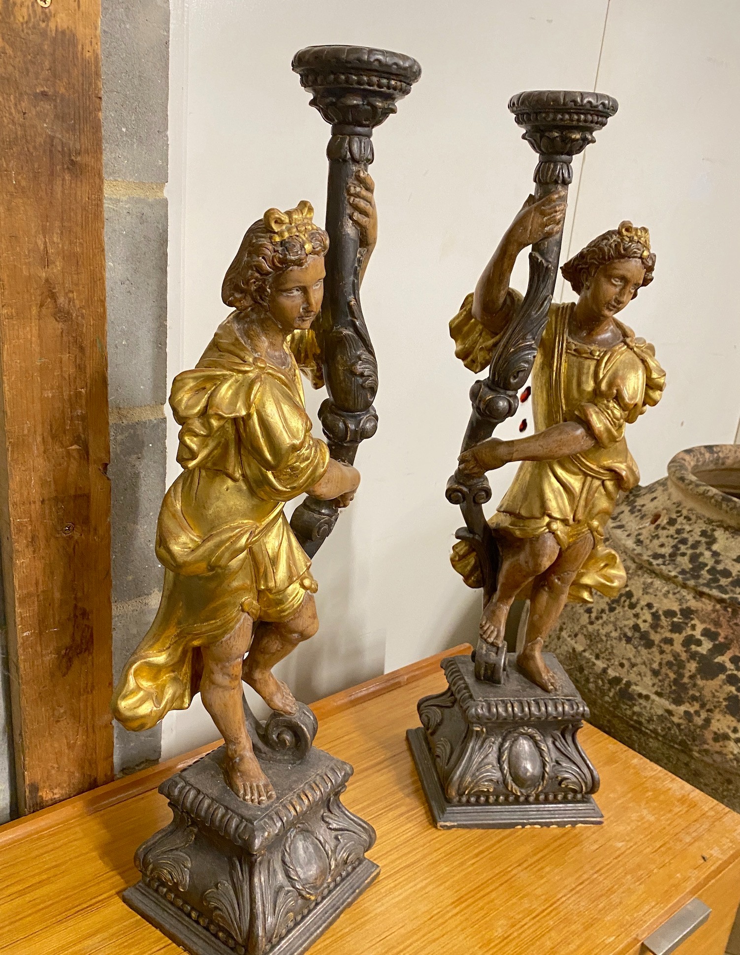 A pair of 18th century style carved pine parcel gilt figural lamp bases, height 75cm